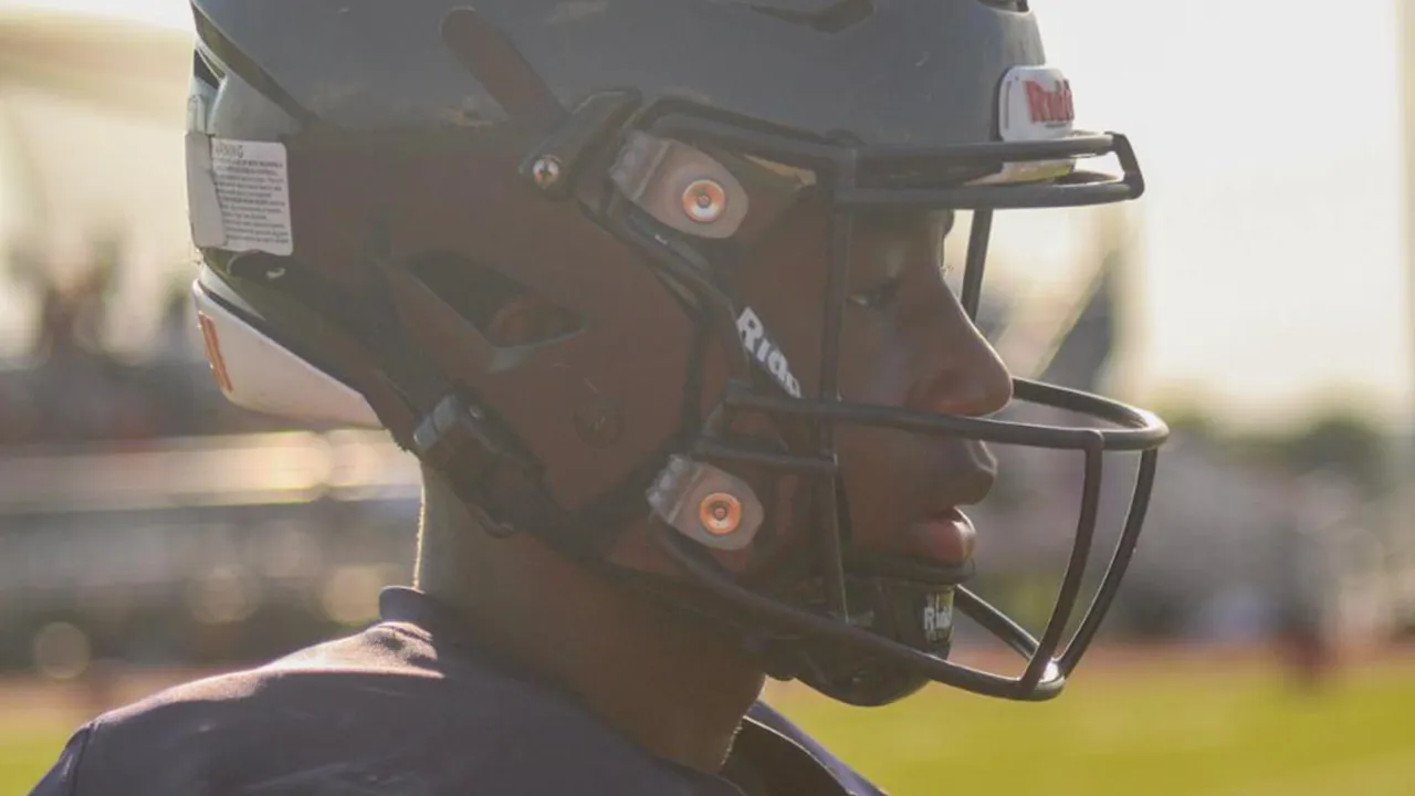 Close up silhouette of Major Curry in full Shoemaker football uniform